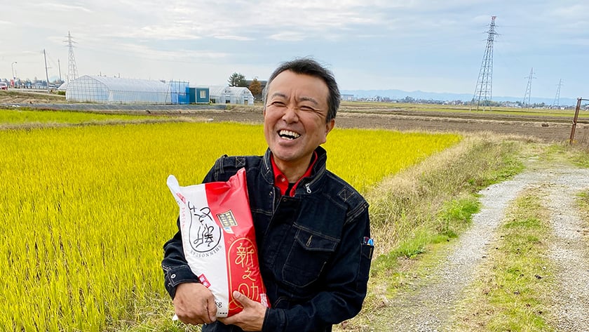Mr. Takayoshi Misawa from Farm Koguriyama in a field with rice